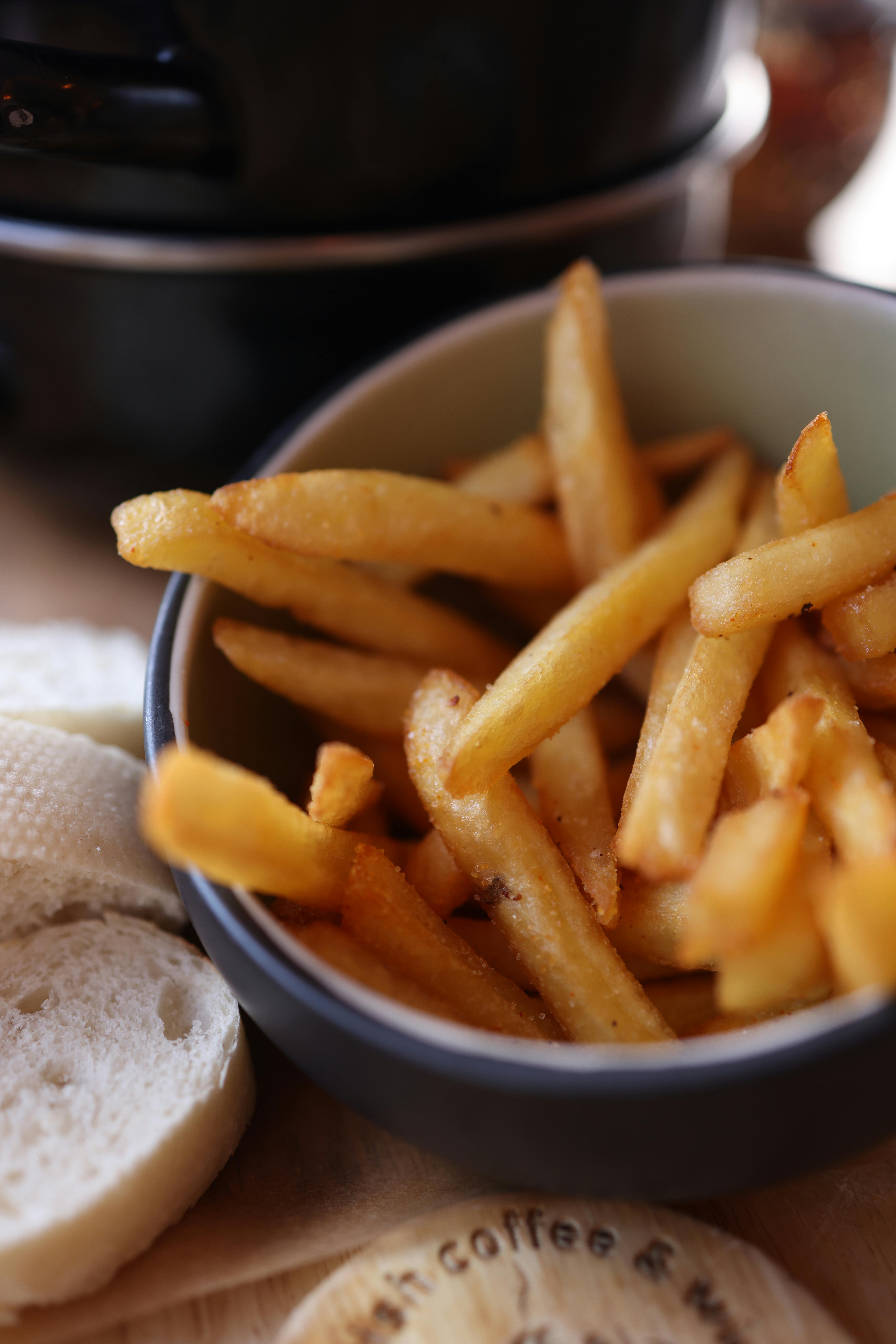 Delicious golden french fries in a bowl, perfect snack or side dish.